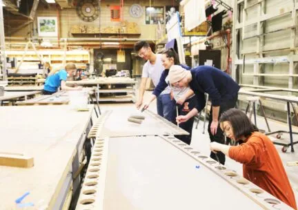 5 students working in scene shop at Krannert Center for the Performing arts