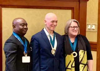 Bill Sullivan with medal and two CELA members