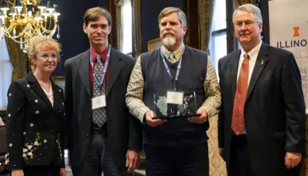 Brian Deal and three other people standing with award