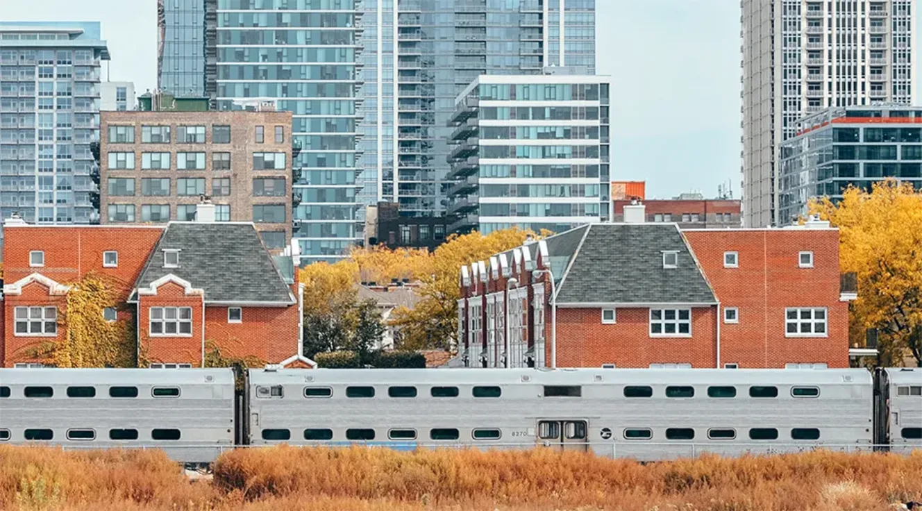 View of open space, train line, and residential buildings in Chicago, IL