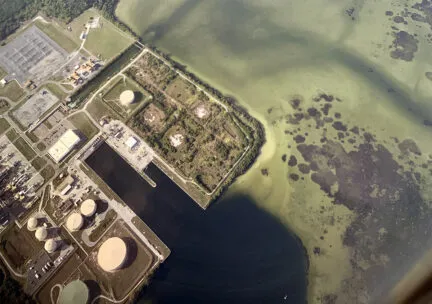 Aerial view of industrial sites and dredging lines along west coast of Florida north of Sarasota.