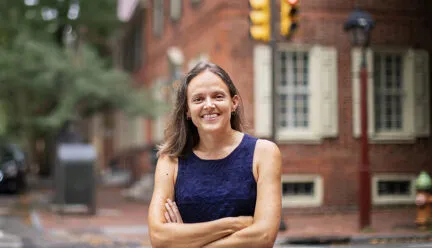 Portrait of Francesca Ammon standing near a street corner in Philadelphia, PA