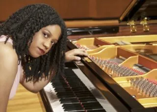 person with piano looking at camera