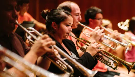 Picture of several students playing the trumpet.