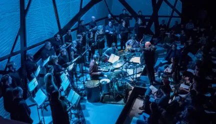 chorus performing in blue light