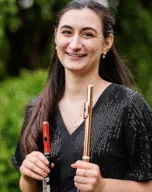 Julia Escobar holding a flute and piccolo
