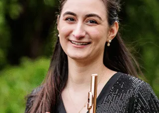 Julia Escobar holding a flute and piccolo