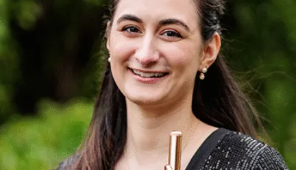 Julia Escobar holding a flute and piccolo
