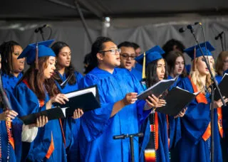 choir members singing at graduation
