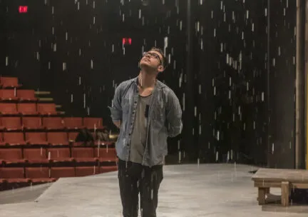 student standing on the stage at Krannert Center