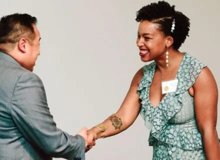 Associate Dean for Advancement Jon Salvani shaking hands with a Legacy Award recipient at the ceremony.