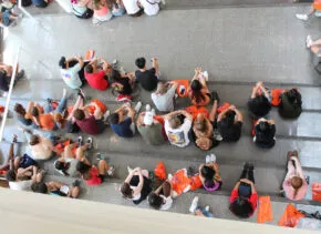 top down view of large group of students in TBH for new student welcome
