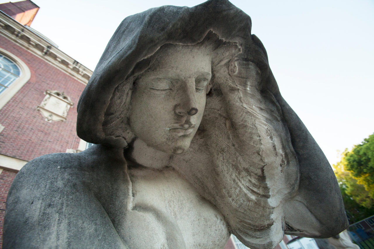 Up close shot of female statue with closed eyes, looking down