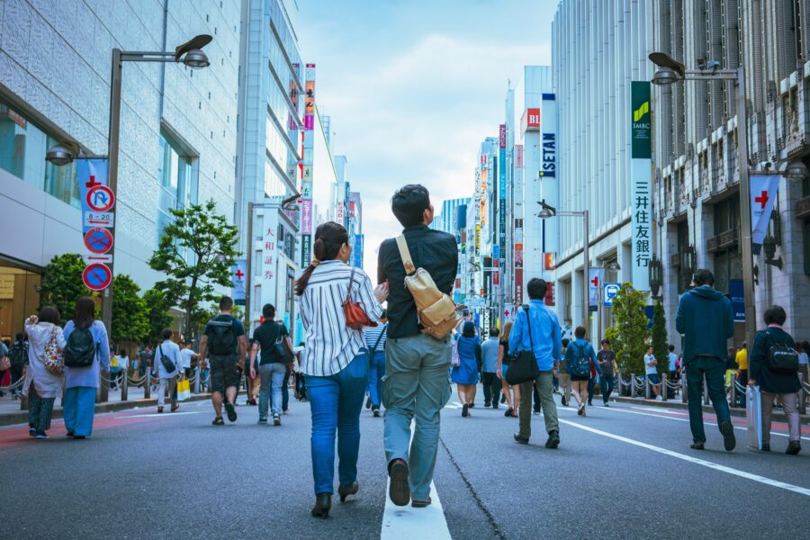 students walking in city from behind