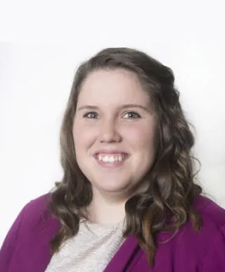 person with long brown hair and dark magenta sweater