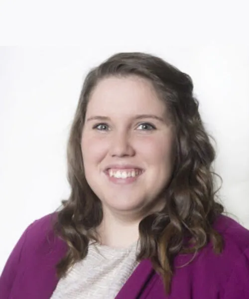 person with long brown hair and dark magenta sweater