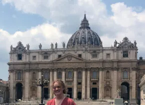 person standing in front of a domed building