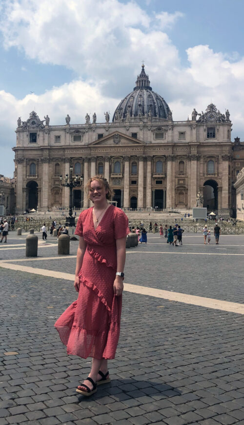 person standing in front of a domed building