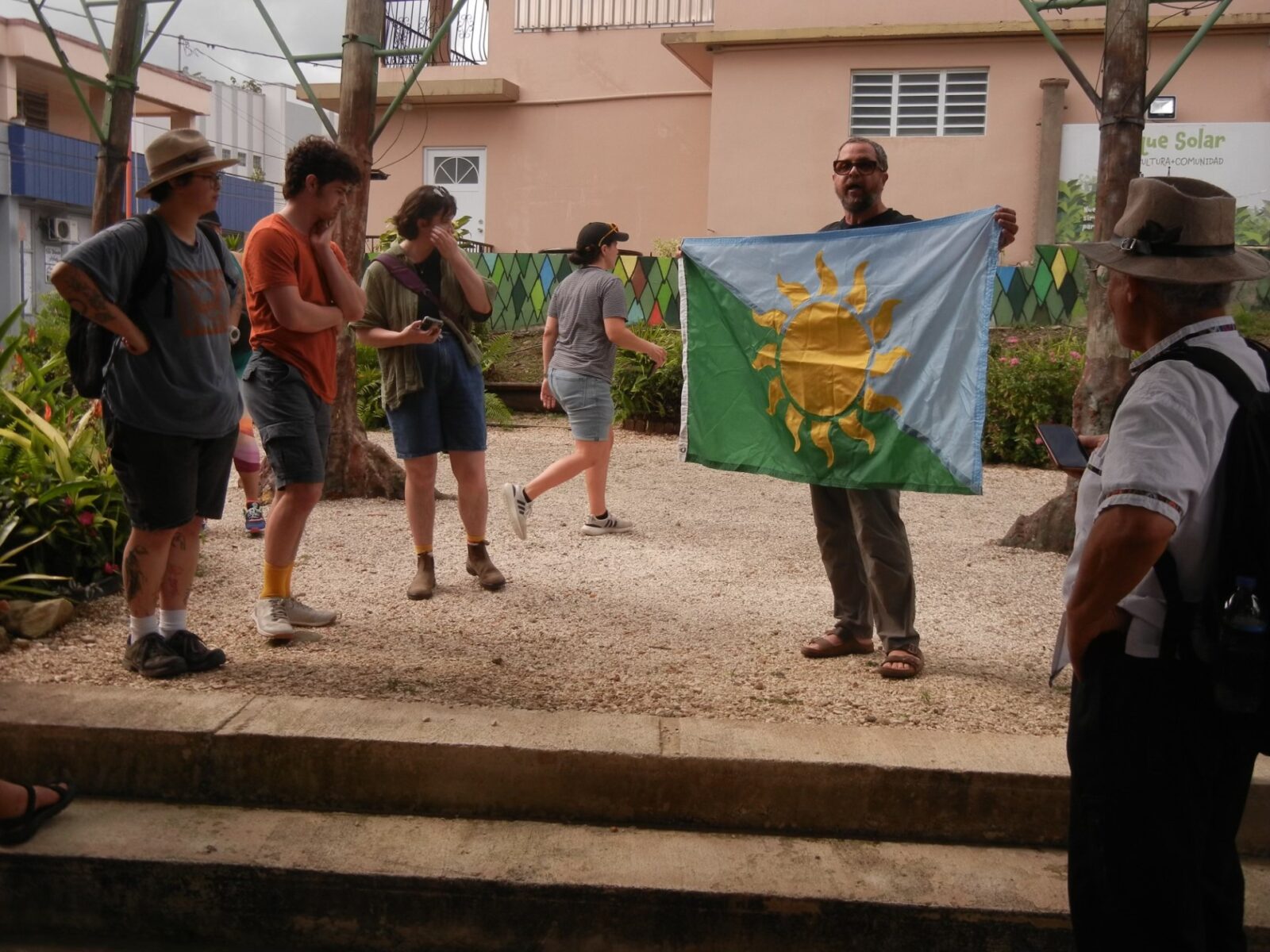people standing around looking at a flag