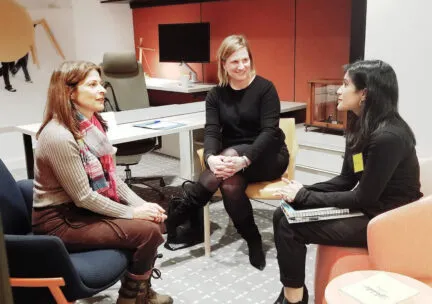 three people sitting in an office