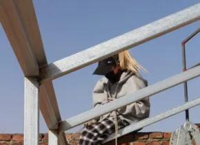 person sitting on building constructing