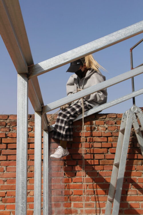 person sitting on building constructing