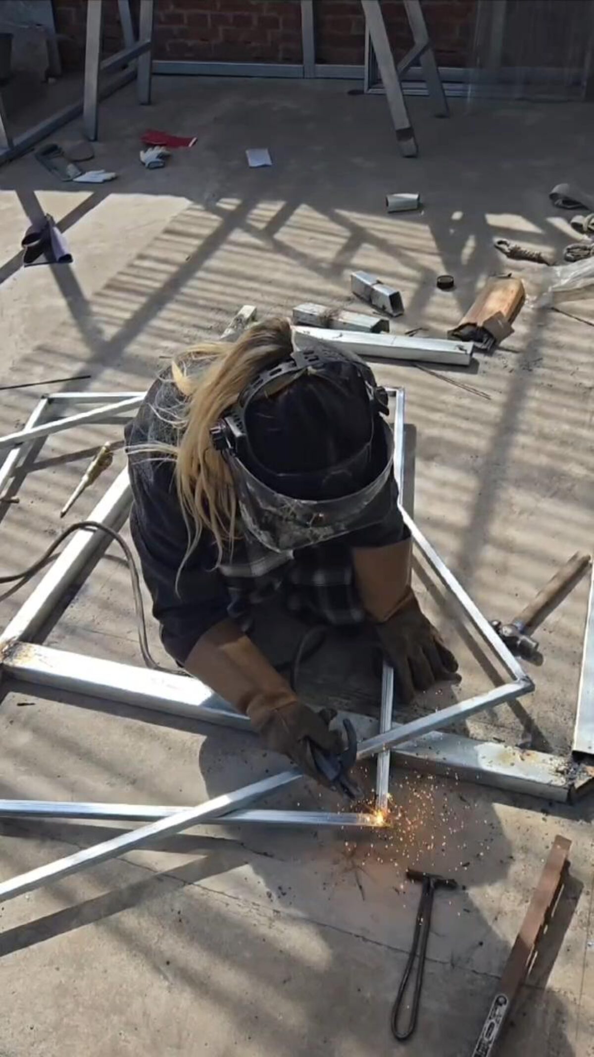 person working with metal beams