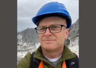 tom leslie wearing a blue hard hat