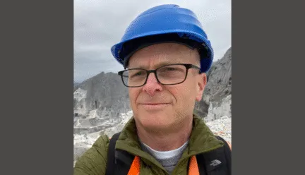 tom leslie wearing a blue hard hat