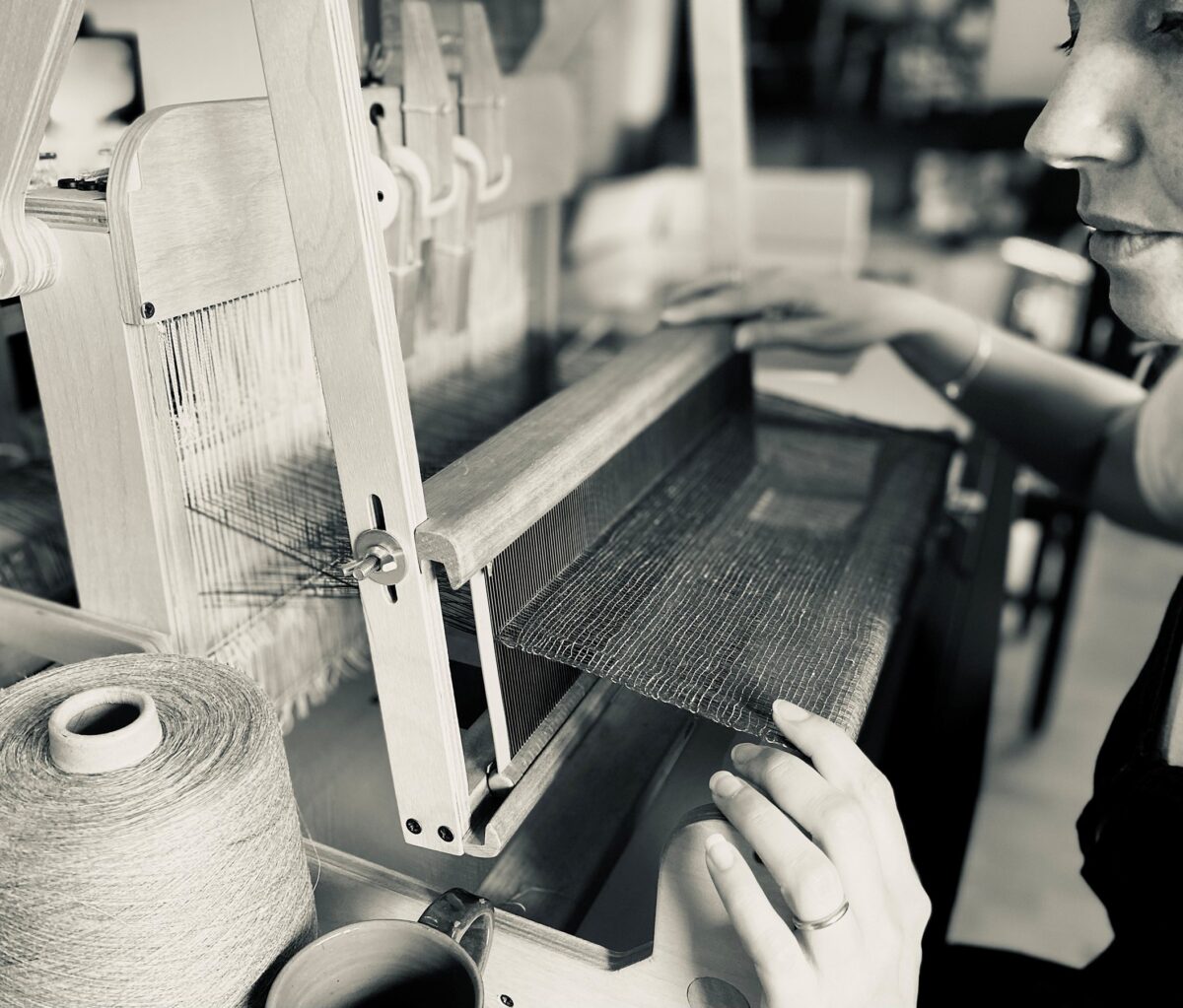 person at weaving machine