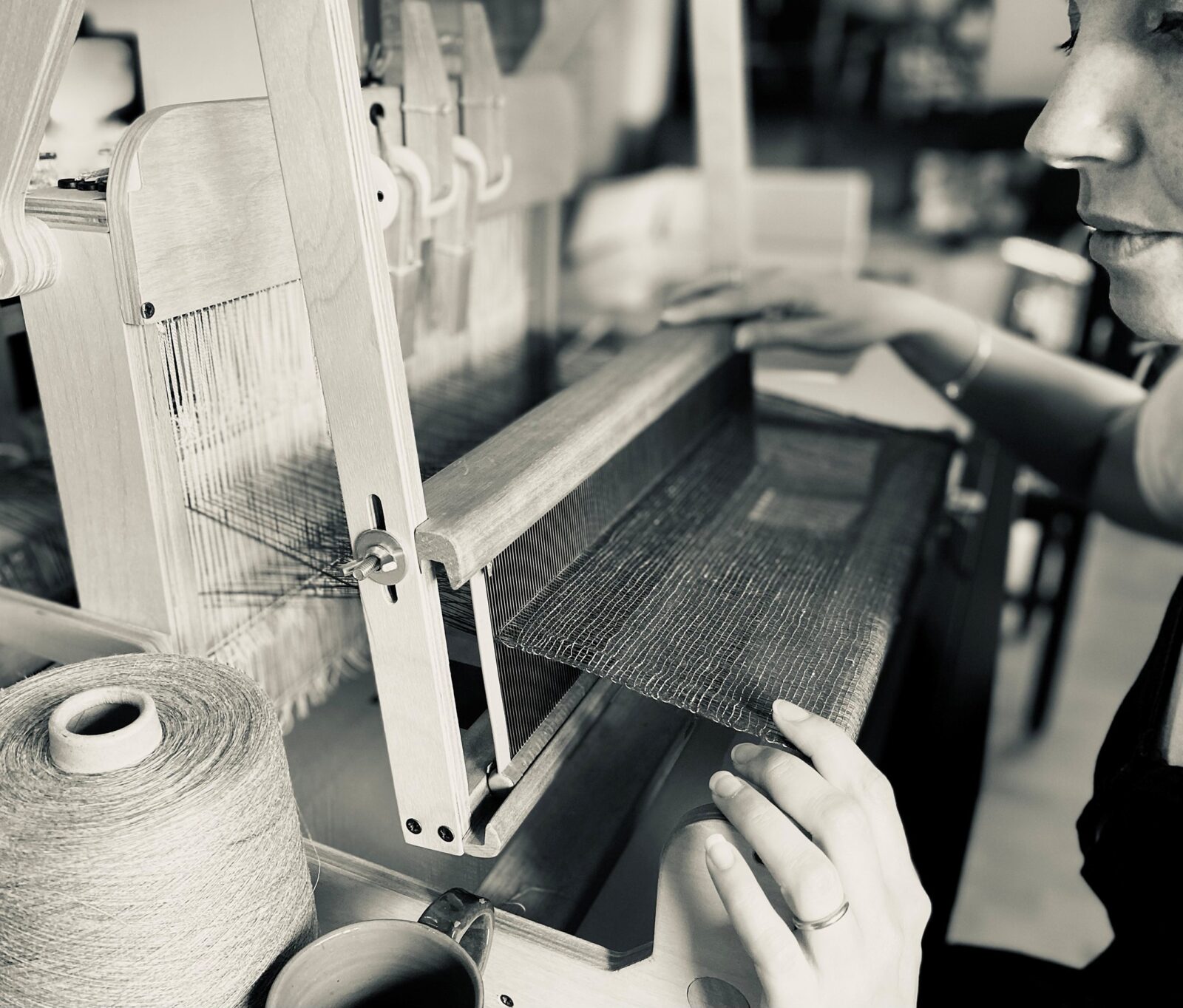 person at weaving machine