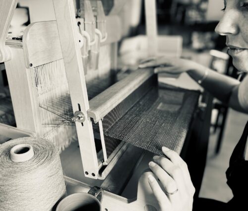 person at weaving machine