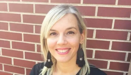 chiara wearing a black shirt and a brick wall behind