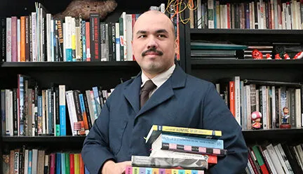 Photo of man with books