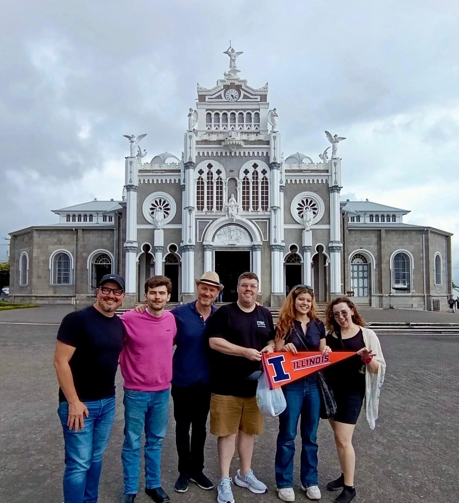 people gathered in front of a large old building
