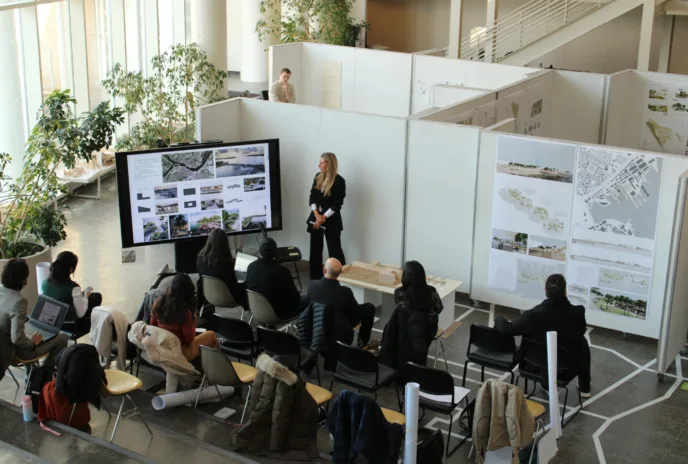 students gathered around big white boards