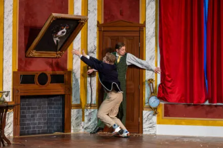 actor slides down a ramp onstage