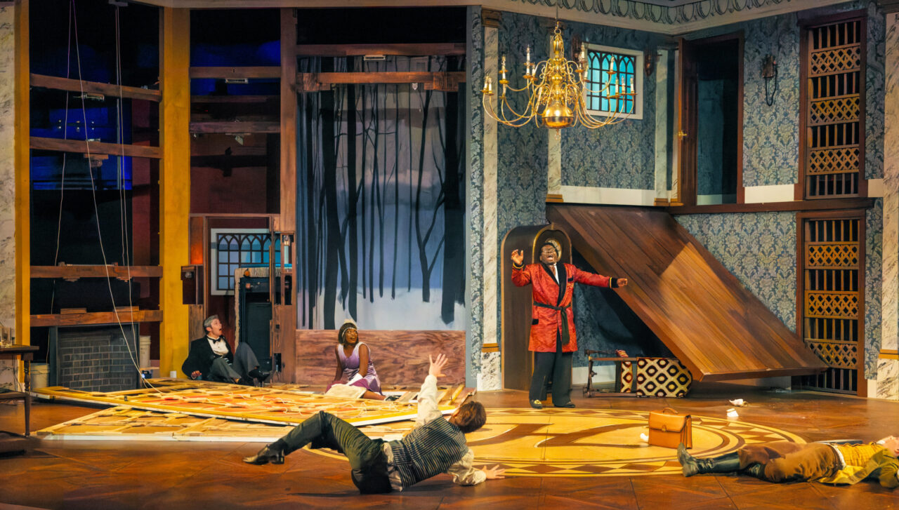 actors onstage with a set deliberately broken all around them