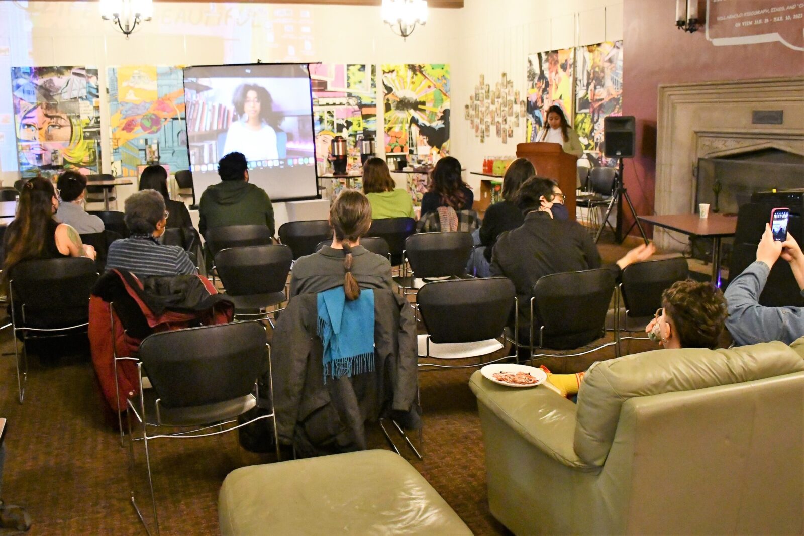 people sitting together watching Gumbs on a screen