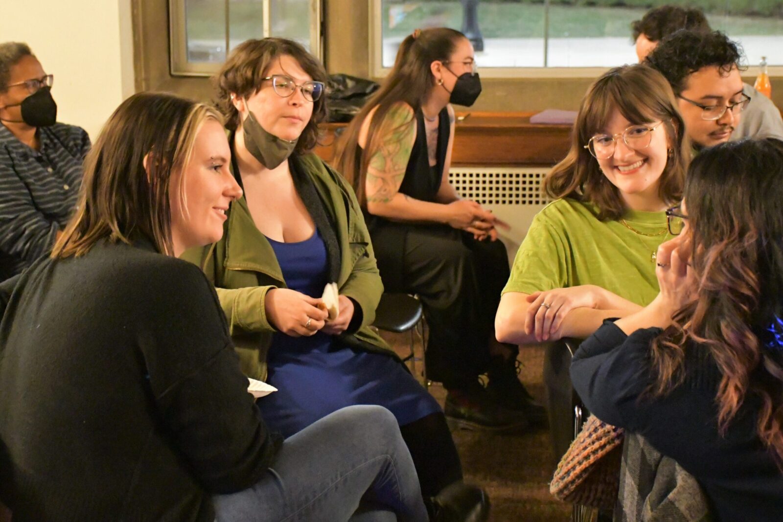 people talking while sitting in chairs