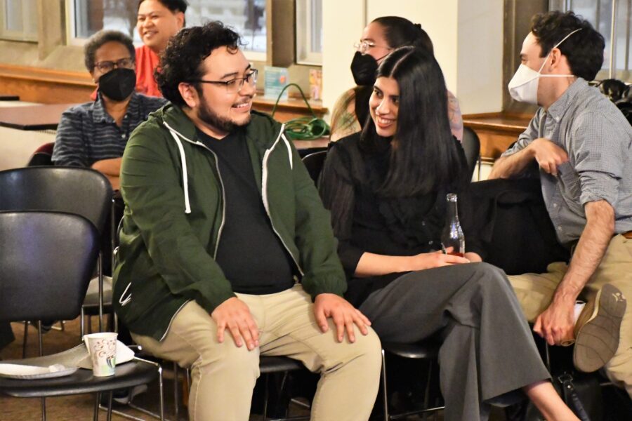 several people sitting in chairs conversing