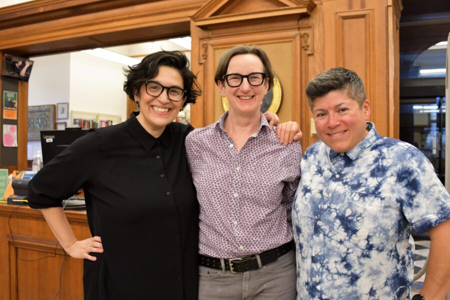 3 people standing and smiling