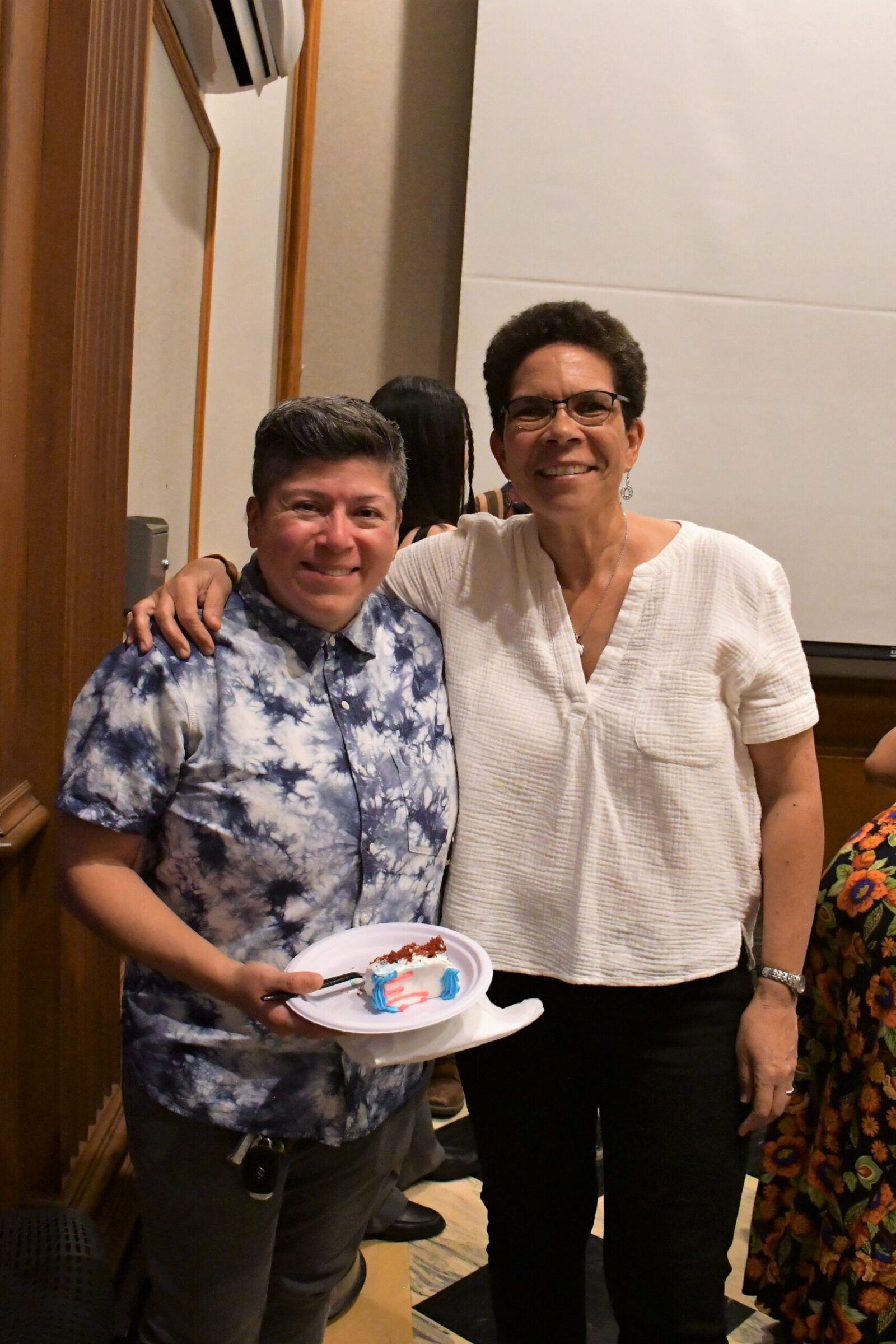 2 people smiling and standing