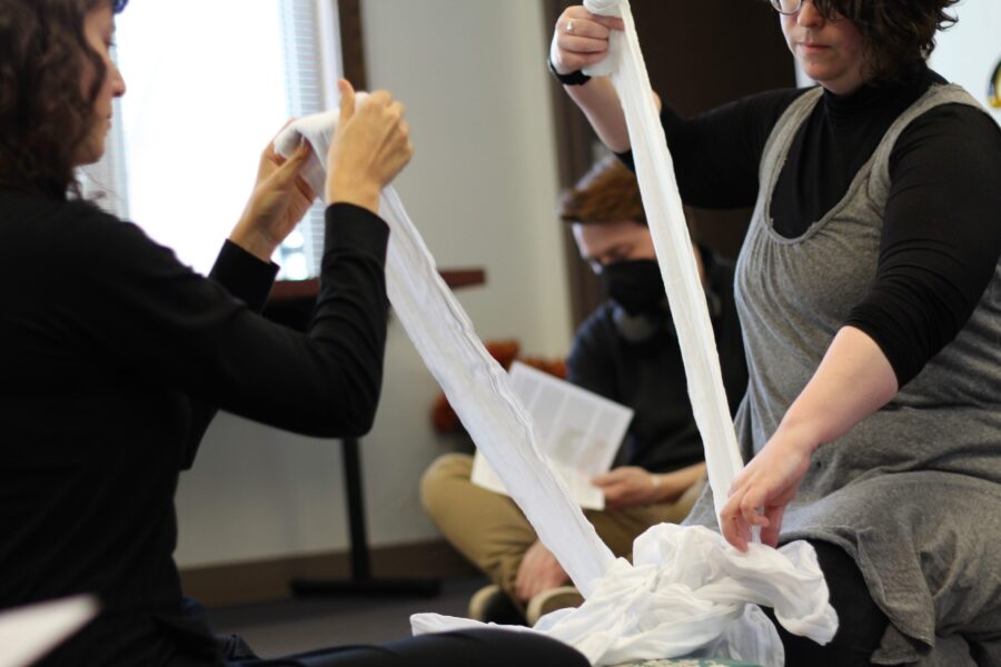 two people pulling pieces of fabric