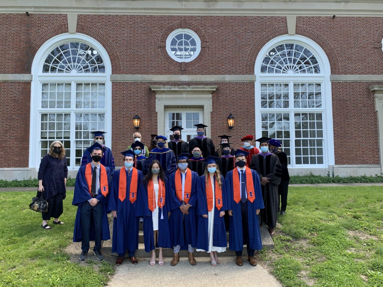 BAUSP graduates and faculty posing in front of Stock Pavilion