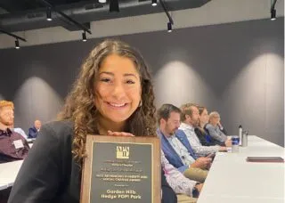 Photo of Roya holding APA-IL award in conference room