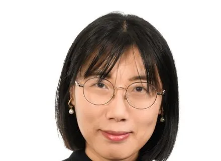 headshot of kerry fang wearing glasses and a black sweater