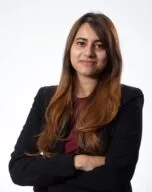 Phot of Sutapa Banerjee in black blazer in front of white background