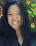 Photo of Melanie Pane in front of vining yellow flowers