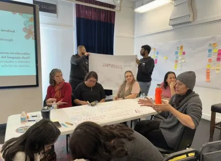 Group of community members working around a table
